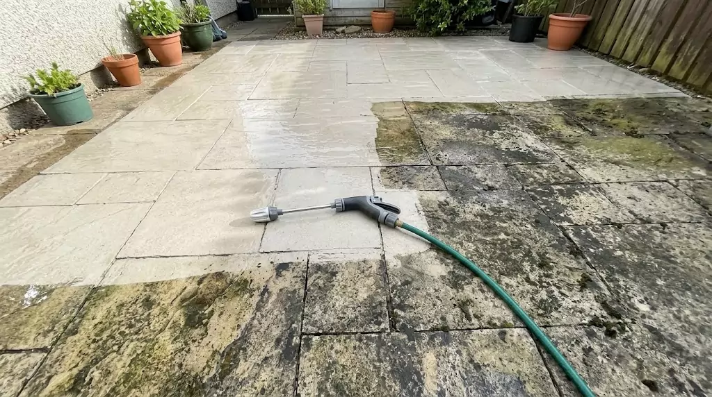 Power Blast test on a 350-sq-ft stone patio — clear line between cleaned and uncleaned section
